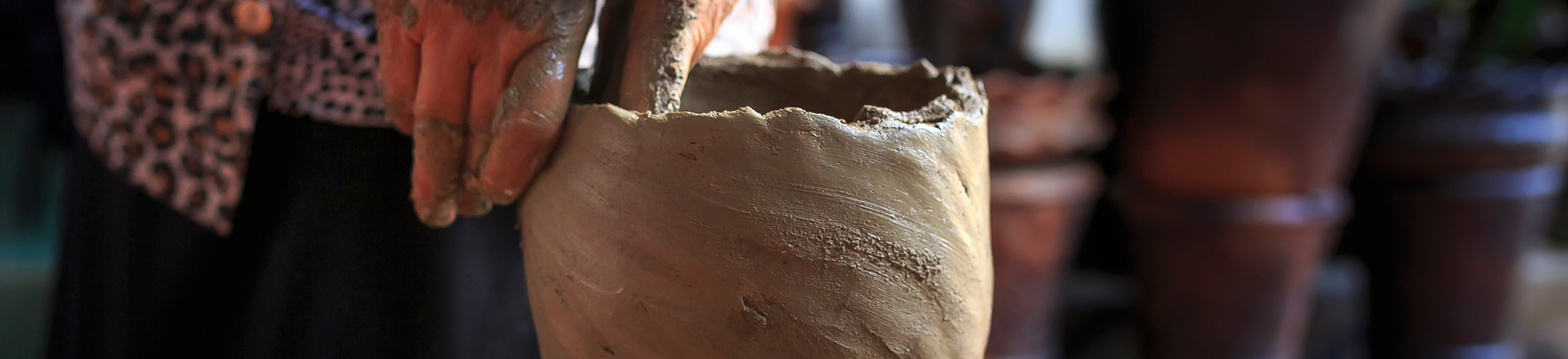 Canva   person molding clay pot